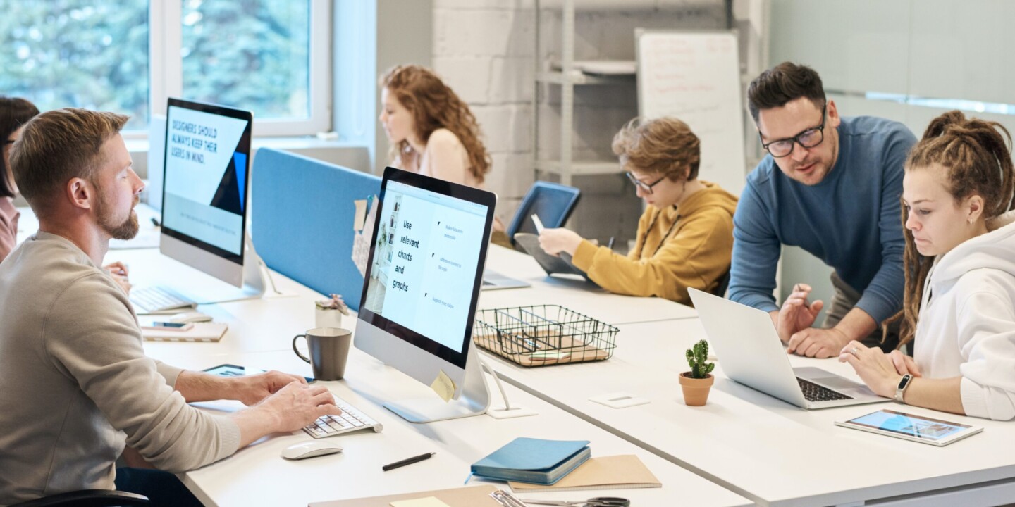 Group of men and women working in office